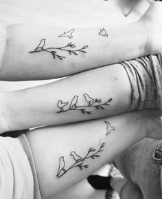 two people with matching tattoos on their arms