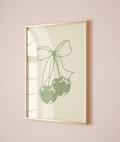 an image of cherries hanging on the wall with a bow around it's neck