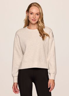 Our In The Studio Cropped Pullover combines a classic crewneck design and super soft, trendy scuba fabric for a lightweight pullover you can take from studio to street. A slightly cropped length is complemented by a relaxed fit, dropped shoulders and sporty seaming detail that allow for easy styling and layering. Throw this cute crop sweatshirt over a sports bra for a workout or pair it with jeans for a casual-cute look. Versatile Crew Neck Tops With Ribbed Cuffs, Crew Neck Relaxed Fit Cropped Sweater In Athleisure Style, Athleisure Relaxed Fit Crew Neck Cropped Sweater, Versatile Crew Neck Sweatshirt For Layering, Stretch Crew Neck Sweatshirt With Ribbed Waistband, Stretch Sweatshirt With Ribbed Waistband And Crew Neck, Crew Neck Cropped Sweater For Loungewear, Relaxed Fit Ribbed Waistband Crew Neck Cropped Sweater, Versatile Crew Neck Sweatshirt For Spring