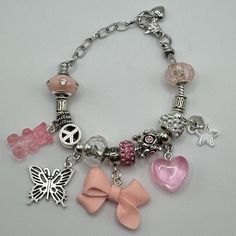 6.3 inch silver bracelet (adjustable-fits most kids 4+, teens, and adults) Included:  6-8 fashion beads (combination of silver and color)  3 silver charms: butterfly, star, and mini heart  3 chunky charms (gummy bear, chunky heart, lollipop, mason juice glass, sweet candy bag, etc.) *NOTE: chunky charms are selected randomly to best suit the Arm Candy and coordinate with color unless specific special request(s) are made in order notes*  The styles pictured are available as is Nickel-free Pink Bracelets For Friendship, Pink Nickel-free Charm Bracelet, Adjustable Pink Beaded Bracelet With Silver Beads, Hypoallergenic Pink Charm Bracelet For Friendship, Nickel Free Pink Charm Bracelet, Adjustable Pink Nickel-free Charm Bracelet, Adjustable Pink Beaded Nickel-free Bracelets, Adjustable Nickel-free Pink Charm Bracelet, Nickel-free Pink Charm Bracelet