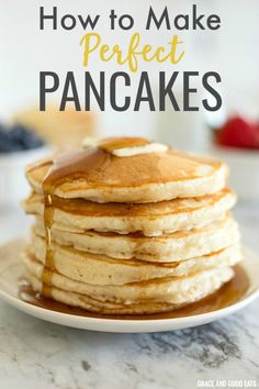 pancakes stacked on top of each other with syrup being drizzled over them