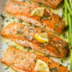 salmon and asparagus on a plate with lemon sauce