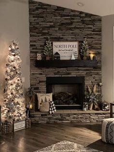 a living room filled with furniture and a fire place next to a christmas tree in front of a stone fireplace