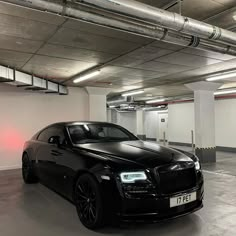 a black car parked in a parking garage