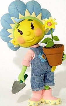 a small doll holding a potted plant with a flower in it's hand