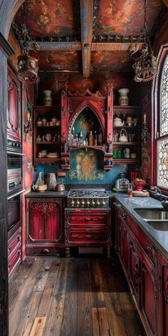 an old fashioned kitchen with wooden floors and red cabinets, painted in the same color as wood