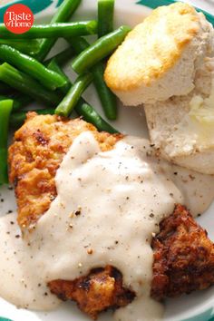 chicken fried with gravy and green beans on a plate