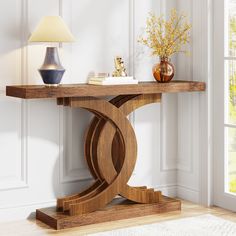 a wooden table with a lamp and vase on it