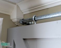 a metal pipe is attached to the side of a wall