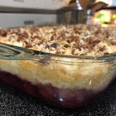 a close up of a pie in a glass dish on a counter top with other dishes behind it