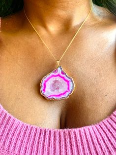 "Vivica" Experience the unique beauty of nature with this large pink geode necklace. With its bold, captivating color and stunning natural crystal formation, it is sure to make a statement and turn heads. Stand out and show off your unique style with this one-of-a-kind geode necklace! 11" Long Pendant: 2" x 1 3/4" 14k Gold-filled Chain Unique Pink Gemstone Necklace, Pink Agate Pendant Jewelry, Pink Agate Pendant Necklace, Pink Agate Gemstone Jewelry, Pink Necklace With Large Pendant, Unique Pink Necklace With Large Pendant, Pink Pendant Crystal Necklace With Natural Stones, Unique Pink Jewelry With Large Pendant, Unique Pink Necklace With Natural Stones