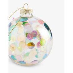 a glass ornament with multicolored confetti on it