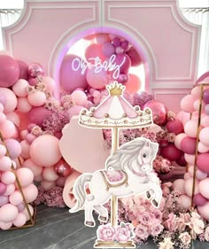 a pink and gold birthday party with balloons, unicorns, and other decorations on the wall