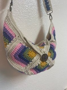 a crocheted purse hanging on the wall