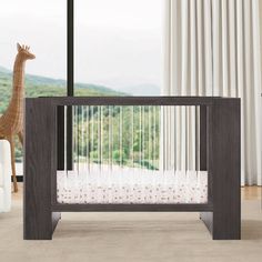 a baby crib with a giraffe in the background