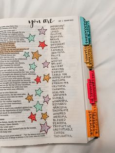 an open bible with colorful stars on the pages and words that spell out you are