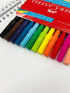 several different colored pens sitting next to each other