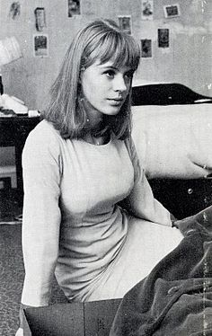 black and white photograph of a woman sitting on a bed