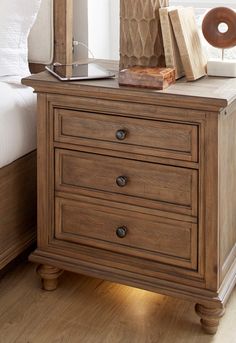 a night stand with two drawers and a lamp on top