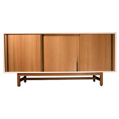 the sideboard is made out of wood and has two doors on one side, and three