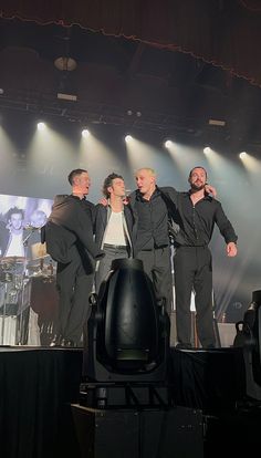 a group of men standing on top of a stage