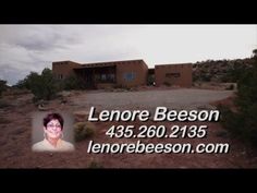 a business card with an image of a woman in front of a house on a hill