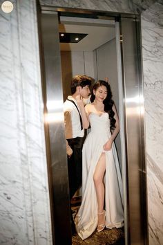 a man and woman standing in an elevator