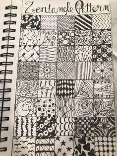 an open notebook with black and white designs on it