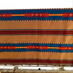 an old native american blanket hanging on a wall