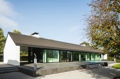 a modern house with glass windows on the roof