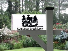 a sign that is in front of some bushes and trees with the name bear creek lane on it