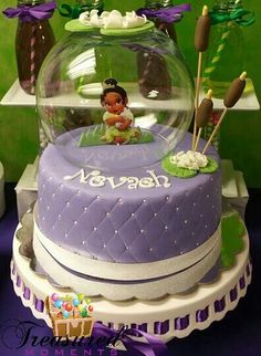 there is a cake that has been decorated in the shape of a snow globe with princess pooh on top