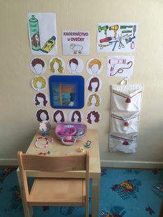 a child's desk and chair in front of a wall with pictures on it