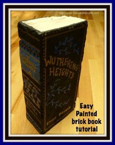 a book with writing on it sitting on top of a wooden table next to a blue frame