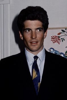 a young man wearing a suit and tie