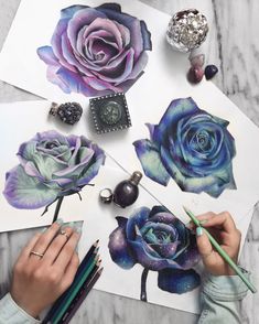 someone is working on some art work with colored pencils and watercolor paper roses