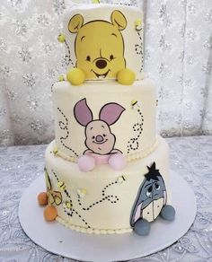 a winnie the pooh birthday cake is decorated with fondant decorations and frosting