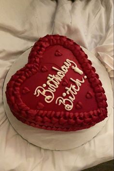 a heart shaped cake with writing on it