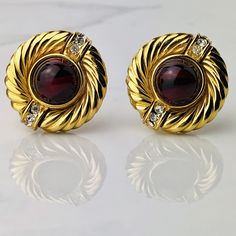 "Vintage 90s Givenchy Paris New York Red Gripoix Glass Cabochon And Clear Crystal Gold Plated Ribbed Design Clip On Earrings.  Fantastic Design To These Amazing 1\" Givenchy Earrings.  Beautiful Circular Shape With Classic Ribbed Design.  The Gorgeous Red Gripoix Glass Cabochons Have a Multitude of Red Hues Almost With a Painterly Effect.  Similar to a Marble Per Se.  At Each End, These Glossy Gold Plated Earrings Are Accented With Three Sparkling Clear Crystals For Added Flair.  These are Truly Chunky Gold Earrings, Givenchy Earrings, New York Vintage, Givenchy Paris, Bold Earrings, Loop Earrings, New Paris, Knot Earrings, Gold Plated Earrings