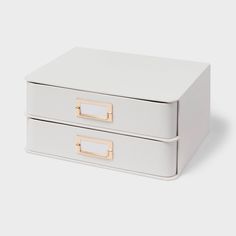 two white leather boxes with gold handles