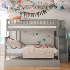 there is a bunk bed in the room with balloons and streamers on the wall