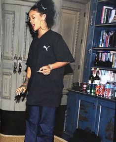 a woman standing in front of a book shelf