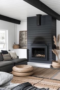 a living room filled with furniture and a fire place in the middle of the room