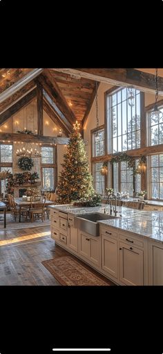 a kitchen with a christmas tree in the center and lots of windows on both sides