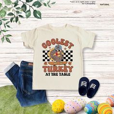 Coolest Turkey At The Table Shirt, Boys Thanksgiving Tee, Turkey Day, Thanksgiving Kids, Thanksgiving Gift, Toddler T-shirt,Thanksgiving Day Important Notice: Please Read Before Placing an Order  Personalization Guidelines:  ● Use the personalization box only to specify design details as shown in the  product images.  ● We are not responsible for any customizations unless requested and approved  prior to placing your order.  Design Details:  ● All designs are created using the Direct to Film (DTF) printing process, which  transfers prints onto fabric or other substrates using a heat press.  How to Order:  1. Review all information provided before placing your order.  2. Select the shirt type and size from the dropdown menu.  3. Choose your preferred shirt color from the dropdown menu.  4. Kids Thanksgiving, Thanksgiving Tee, Order Design, Turkey Day, Thanksgiving Kids, Dtf Printing, At The Table, Thanksgiving Gift, Thanksgiving Shirts