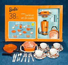 an orange boxed set of kitchenware in a box with matching dishes and utensils