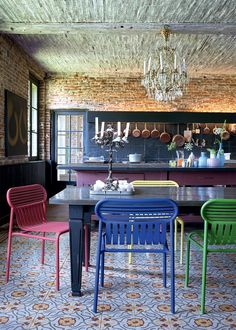 colorful chairs and tables in an old brick kitchen