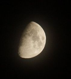 the moon is seen in the dark sky with only one light on it's side