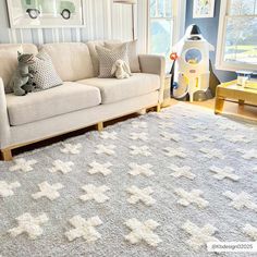 a living room filled with furniture and a white rug