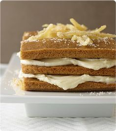 a white plate topped with cake covered in frosting